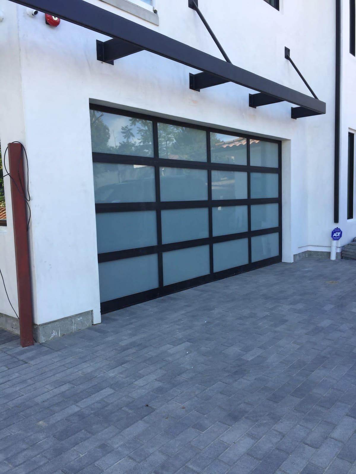 Modern black aluminum and frosted glass garage door