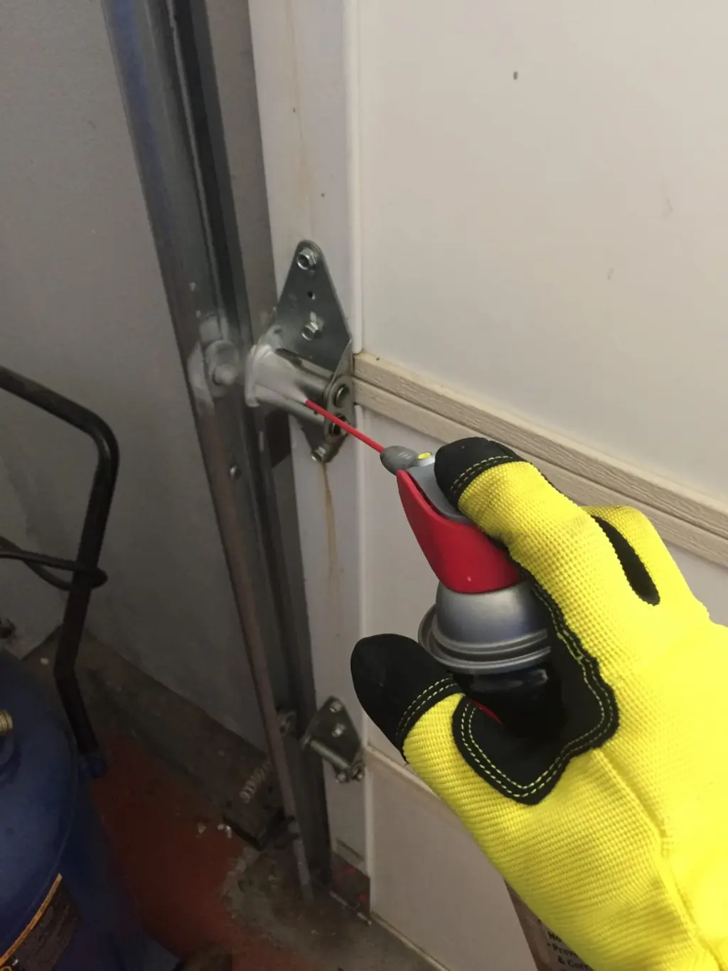 Garage door hardware maintenance and lubrication