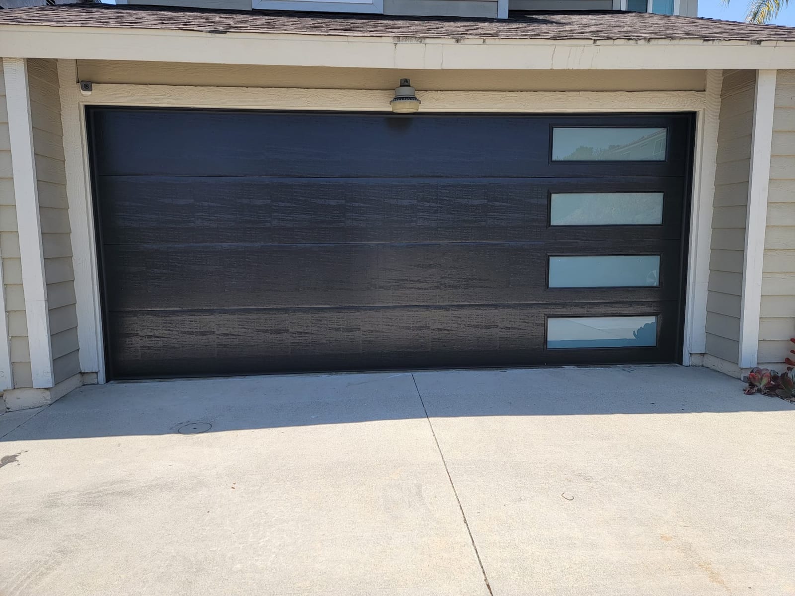 Modern dark garage door with windows