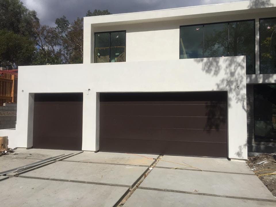 Modern dark garage doors on a new build home