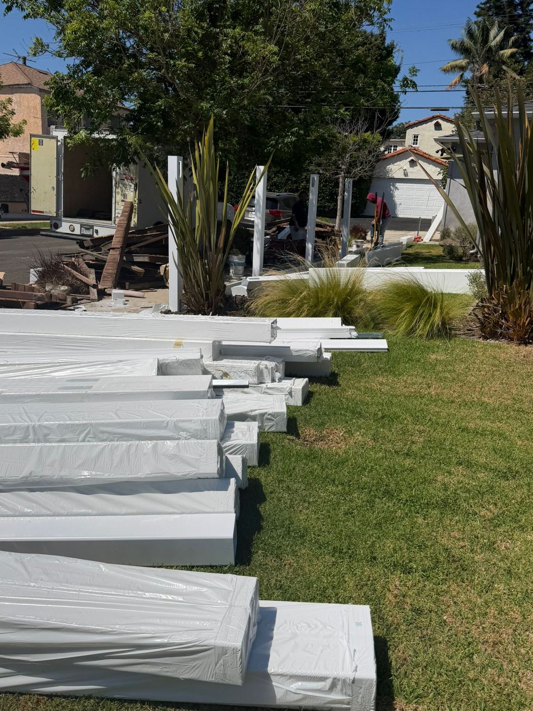 Vinyl fence panels and posts delivered to a job site