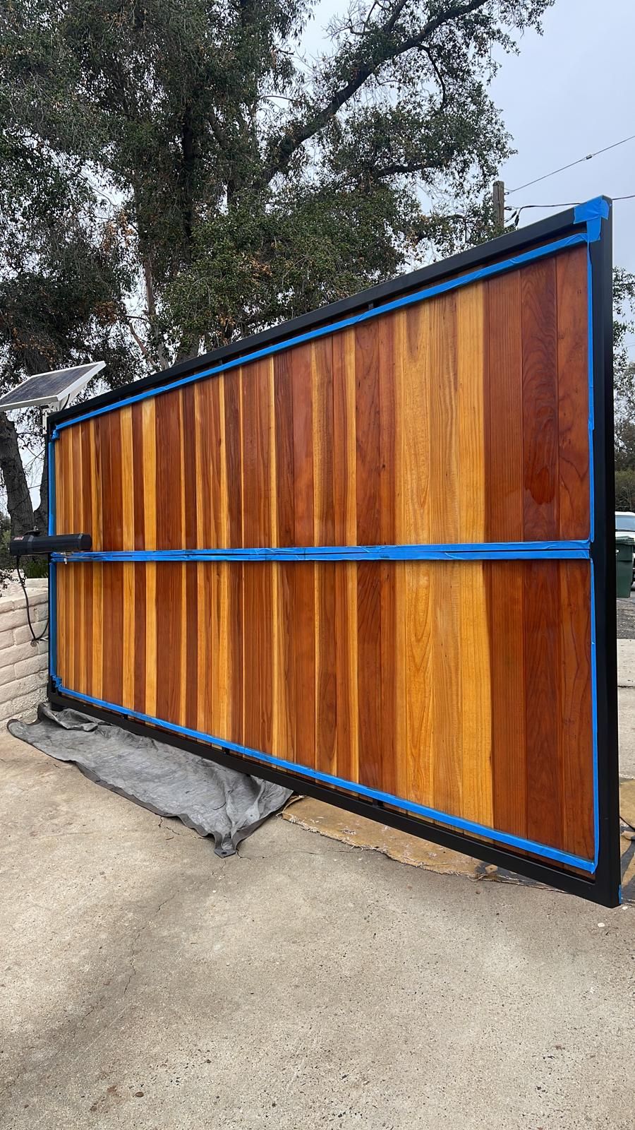 Redwood gate being stained