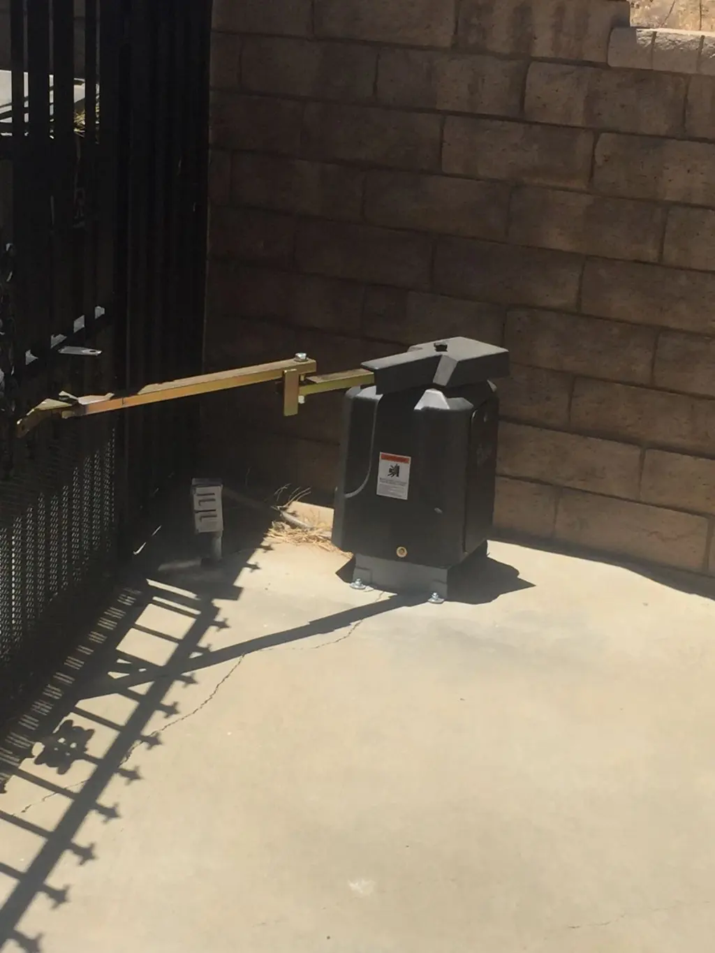 Swing gate operator on an iron gate