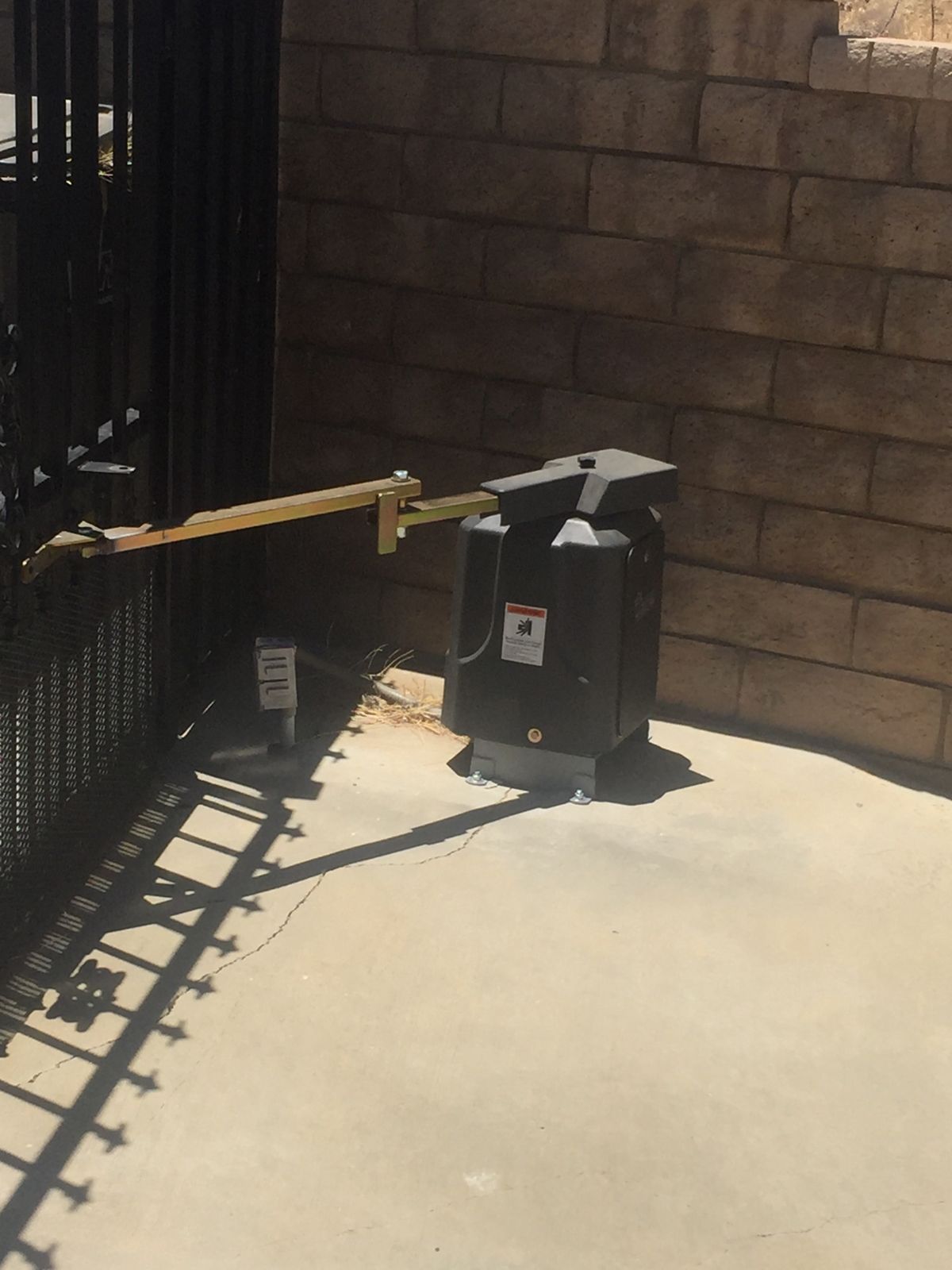 Swing gate operator on an iron gate