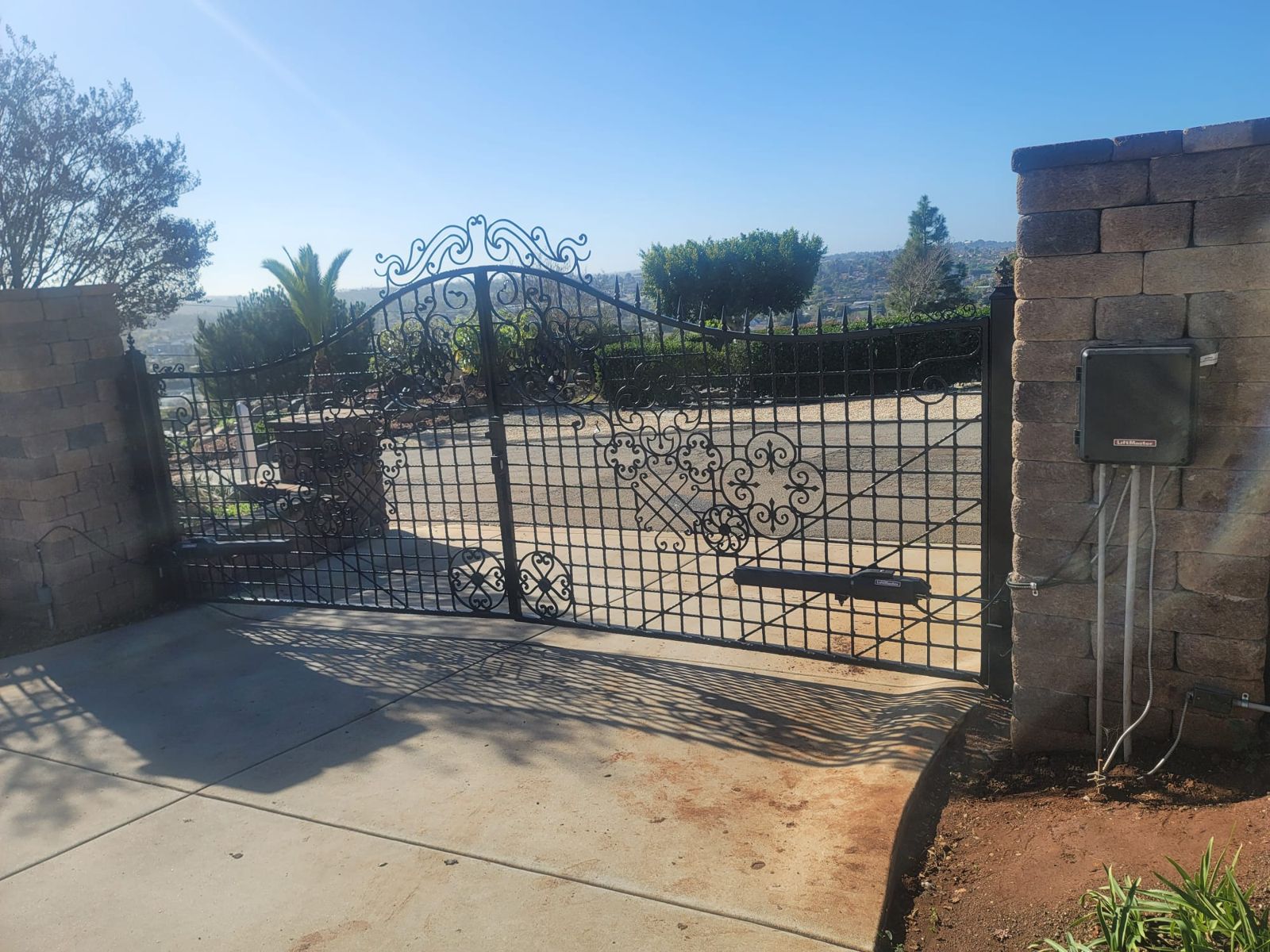 Wrought iron double swing gate with an automatic opener