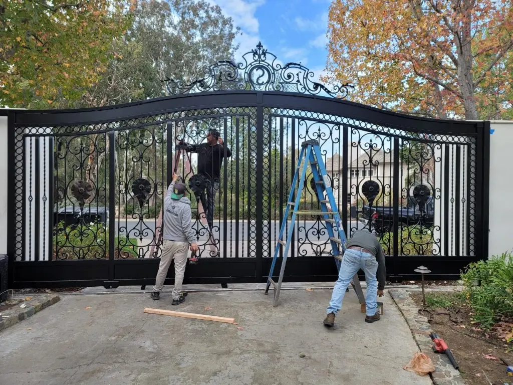 AER crew installing a wrought iron driveway gate